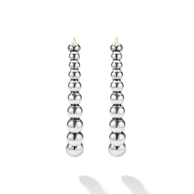 front of oval-shaped sterling silver beaded hoop earrings