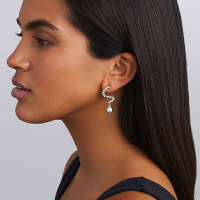 woman wearing silver beaded statement drop earrings with large hanging bead