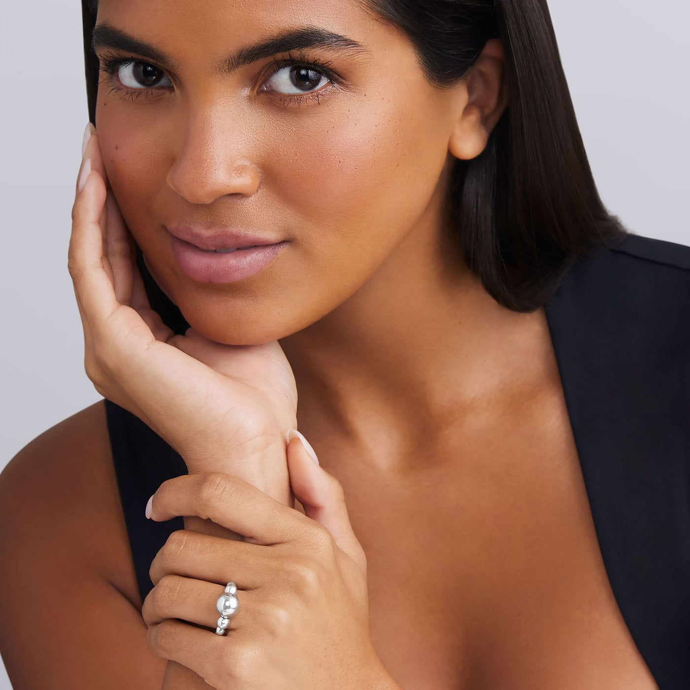 woman wearing sterling silver small to large beaded ring